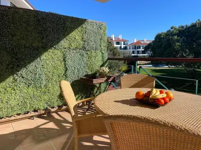 a table with a bowl of fruit on a balcony at House of Rising Sun in Quarteira