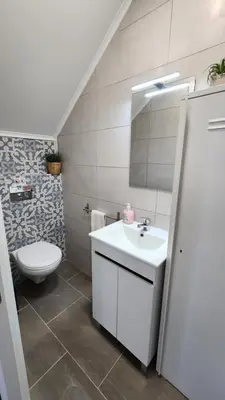 a bathroom with a white sink and a toilet at Casa do Sol Faro in Faro