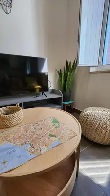 a coffee table in a living room with a tv at Casa do Sol Faro in Faro