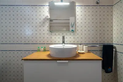 a bathroom counter with a sink and a mirror at SILCHORO - Estúdio remodelado com AC e piscina in Albufeira