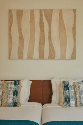 a bedroom with a large bed and a chandelier at Villa Monte das Oliveiras with Private Pool in Albufeira