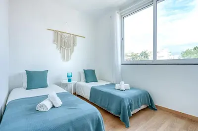 a room with two beds and a window at Faro Center with AC & WiFi in Faro