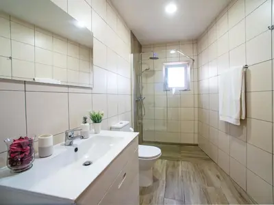 a bathroom with a sink and a toilet and a mirror at Holiday Home Sebastião by Interhome in Paderne