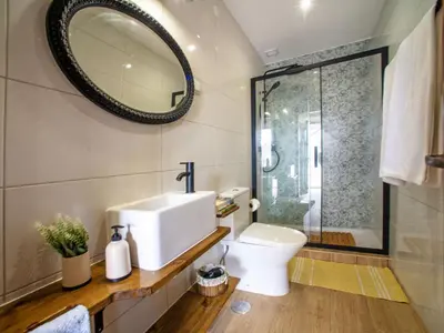 a bathroom with a sink and a toilet and a mirror at Holiday Home Eugênia by Interhome in Paderne