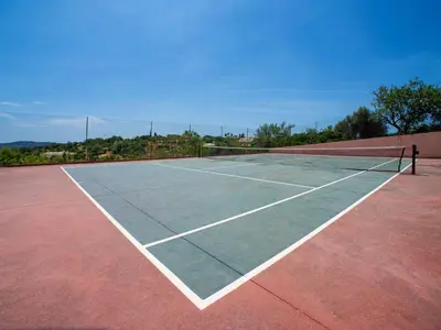 a tennis court with a net on top of it at Holiday Home Eugênia by Interhome in Paderne