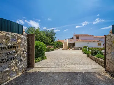 a gate to a house with a stone wall at Holiday Home Eugênia by Interhome in Paderne