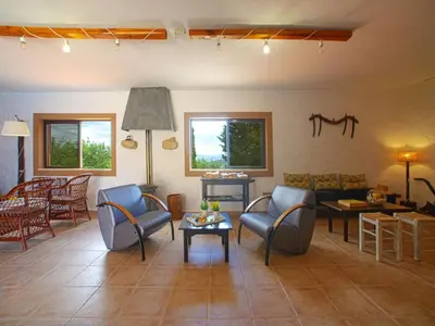 a living room with chairs and a couch and a table at Holiday Home Eugênia by Interhome in Paderne
