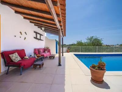 a patio with a couch and a table with food on it at Holiday Home Ana by Interhome in Paderne