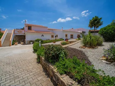 a swimming pool with chairs and umbrellas on a balcony at Holiday Home Ana by Interhome in Paderne