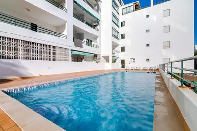 a swimming pool in the middle of a building at AL - Apartamento Pérola in Quarteira