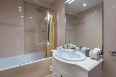a white bathroom with a sink and a shower at Place in the sun - Free out door Jacuzzi - BY BEDZY in Albufeira
