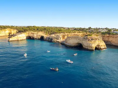 a group of boats in the water near cliffs at Villa Bahia by Algarve Vacation in Albufeira