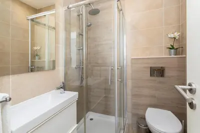 a bathroom with a shower and a toilet and a sink at Centralgarve - Stunning Beach Front Studio - Astro in Quarteira