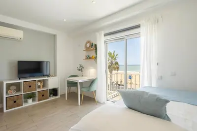 a white cabinet with a tv and a plant at Centralgarve - Stunning Beach Front Studio - Astro in Quarteira