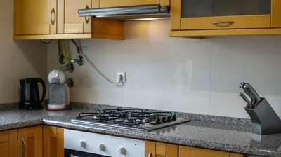 a stove top in a kitchen with wooden cabinets at Albufeira Stylish Townhouse in Albufeira