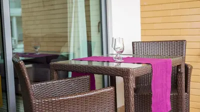 a table and two chairs with a pink napkin at Albufeira Stylish Townhouse in Albufeira