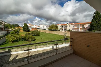 a balcony with a view of a yard at Albufeira Stylish Townhouse in Albufeira