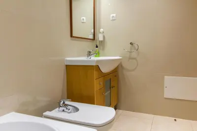 a bathroom with a sink and a toilet and a mirror at Albufeira Stylish Townhouse in Albufeira