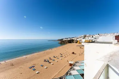 a view of a beach with umbrellas and the ocean at Casa dos Sonhos Albufeira in Albufeira