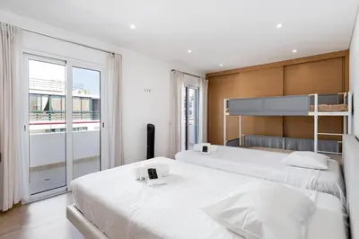 a bedroom with two beds and a large window at Centralgarve - Beachfront with Pool Penthouse in Quarteira