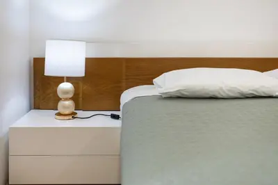 a bedroom with a bed and a lamp on a nightstand at Centralgarve - Beachfront with Pool Penthouse in Quarteira