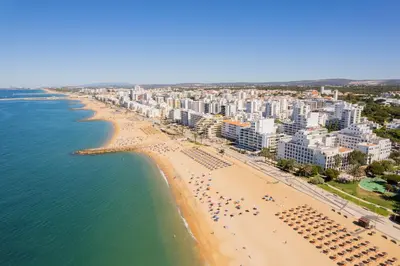 an aerial view of a beach in malta at Centralgarve - Beachfront with Pool Penthouse in Quarteira