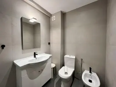 a bathroom with a sink and a toilet and a mirror at Albufeira Downtown With Pool by Homing in Albufeira