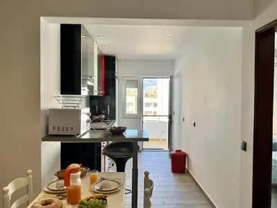 a kitchen with a table with food on it at Albufeira Downtown With Pool by Homing in Albufeira