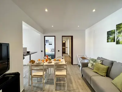a living room with a table and a couch at Albufeira Downtown With Pool by Homing in Albufeira
