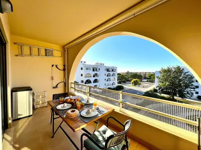a balcony with a table and a view of a street at Albufeira Salgados Beach 3 by Homing in Albufeira