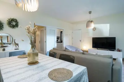 a living room with a table and a couch at ALEGRIA 29 - T2 piso terreo com AC e piscina by My Algarve Rentals in Quarteira