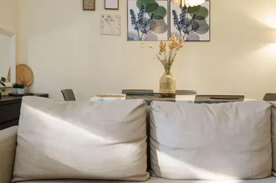 a table with two white pillows and a vase on it at ALEGRIA 29 - T2 piso terreo com AC e piscina by My Algarve Rentals in Quarteira