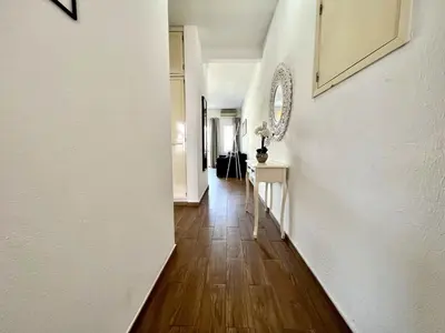 a hallway with white walls and a wooden floor at Vilamoura Central 4 With Pool by Homing in Vilamoura
