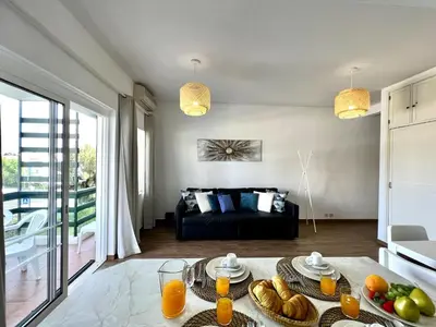 a living room with a table with food on it at Vilamoura Central 4 With Pool by Homing in Vilamoura