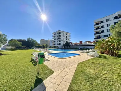 a swimming pool in a park with a building at Vilamoura Central 4 With Pool by Homing in Vilamoura