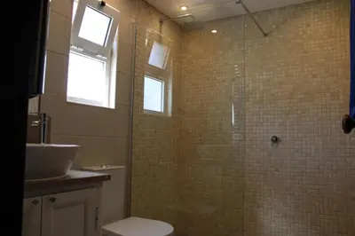 a bathroom with a shower with a toilet and a sink at Villa Seaside in Vale do Lobo