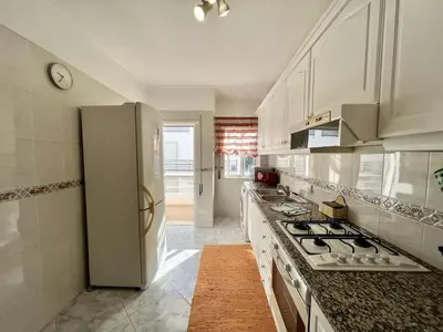 a kitchen with a refrigerator and a stove top oven at Albufeira Falesia Beach 4 by Homing in Albufeira