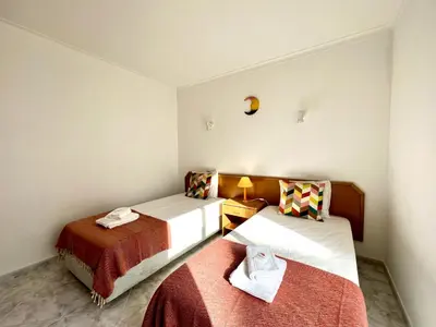 two beds in a small room with at Albufeira Falesia Beach 4 by Homing in Albufeira