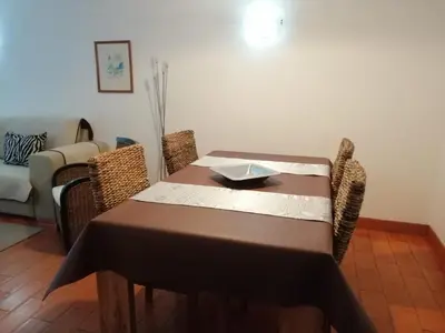 a dining room table with a table cloth on it at Apartment 3 persons in Vilamoura, Algarve in Quarteira