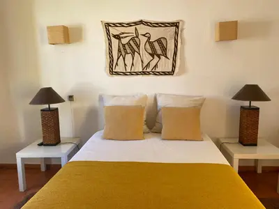a bedroom with a bed with two lamps on two tables at Aldeia do Golf O7 in Quarteira