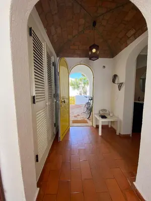a hallway with a yellow door in a house at Aldeia do Golf O7 in Quarteira