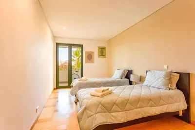 a bedroom with two beds and a window at Marina Vilamoura - Aquamar 006 By Vilamoura Sun in Vilamoura