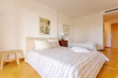a white bedroom with a large white bed in it at Marina Vilamoura - Aquamar 006 By Vilamoura Sun in Vilamoura