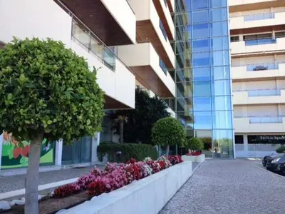 a building with a row of flowers in front of a building at Marina Vilamoura - Aquamar 006 By Vilamoura Sun in Vilamoura