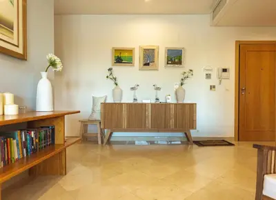 a living room with a table and vases on the wall at Marina Vilamoura - Aquamar 006 By Vilamoura Sun in Vilamoura