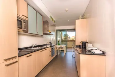 a kitchen with a sink and a counter top at Marina Vilamoura - Aquamar 006 By Vilamoura Sun in Vilamoura