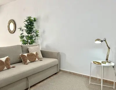 a living room with a couch and a table at Sun II - City center by HD PROPERTIES in Vilamoura