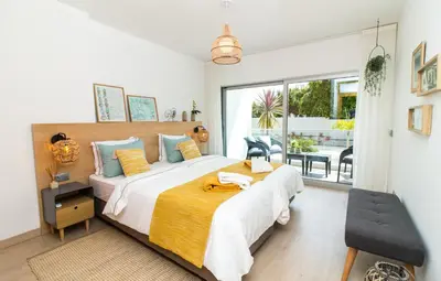 a bedroom with a large bed and a balcony at By the sea, Algarve in Galé