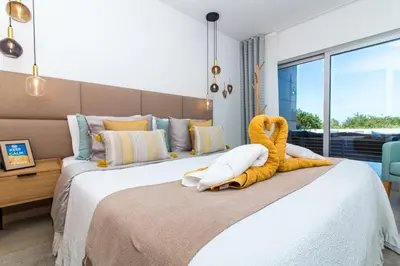 a bedroom with a bed with a stuffed animal on it at By the sea, Algarve in Galé