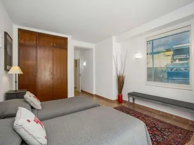 a white bedroom with a large bed and a table at Beautiful Algarve Villa 5 Bedrooms Villa Pilar Amazing Beach & Sea Views in Albufeira
